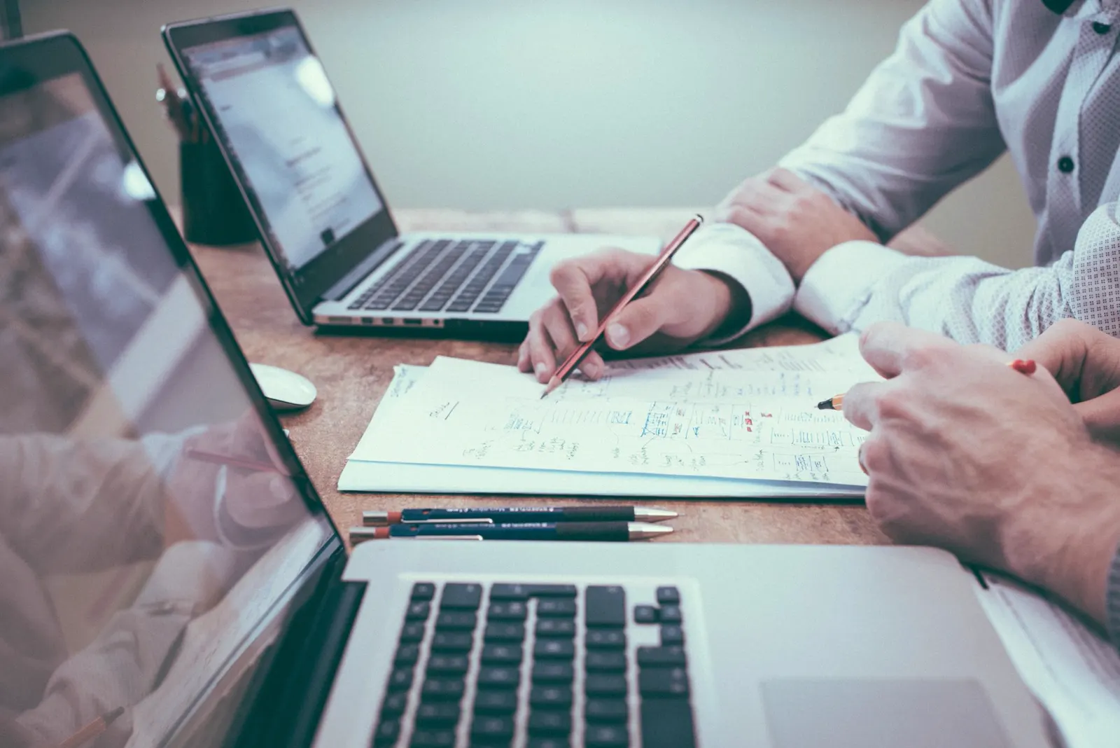 Business team reviewing documents and devices at a desk